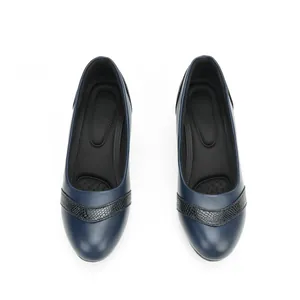 Top-down macro view of navy blue low heel pumps featuring a textured strap design