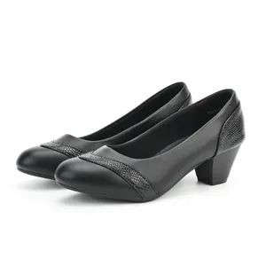 Detail view of black low-heel pumps with snakeskin texture accents and square toe.