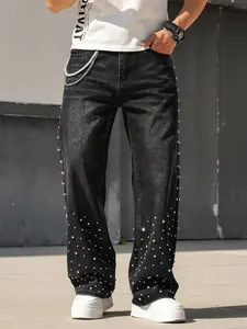 Detail view of men's loose straight-leg jeans with sparkling rhinestone embellishments