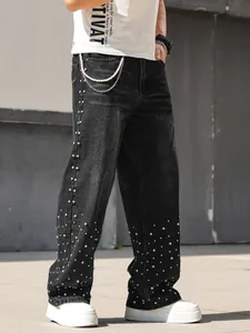 Close-up detail of men's loose straight black jeans with sparkling rhinestone embellishments