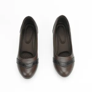 Overhead view of stylish brown soft leather pumps with low chunky heel and square toe