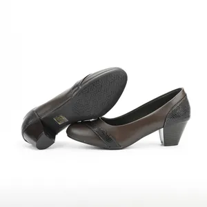 Detailed view of brown low-heel pumps featuring faux-reptile texture and thick heels