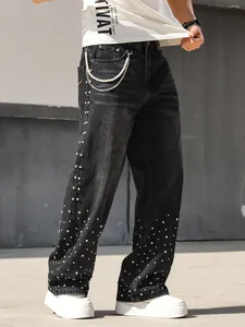 Macro view of men's loose straight denim jeans featuring sparkling rhinestone embellishments.