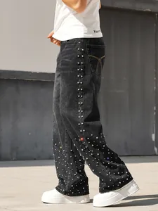 Detail of men's loose straight jeans with sparkling rhinestone embellishments