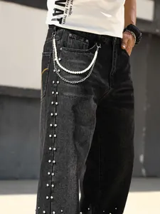Detailed view of men's loose straight jeans with rhinestone sides and pearl chain.