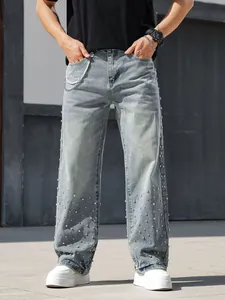 Detail of men's loose straight jeans with rhinestone accents and acid wash denim.