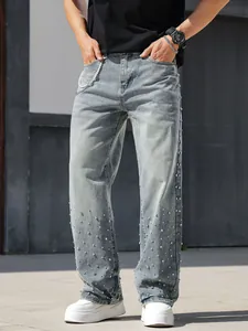 Detail view of men's loose straight-leg jeans with sparkling rhinestone embellishments