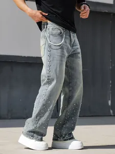 Macro detail view of men's loose straight jeans with rhinestone embellishment and side chain