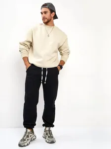 Detailed view of men's black fleece joggers with white drawstring in a casual style