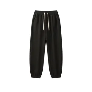 Macro view of black fleece sweatpants with drawstring waist