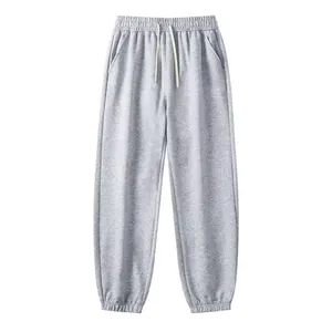 Close-up detail of men's grey fleece joggers with elastic drawstring waist and cuffs