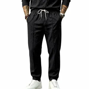 Men's loose black cotton linen pants with drawstring waist and straight leg design