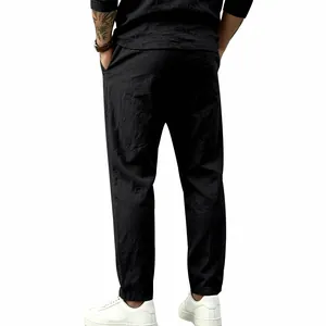 Rear view of comfortable black cotton linen trousers with a loose straight-leg fit for men