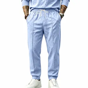 Front view detail of men's light blue cotton linen loose drawstring pants
