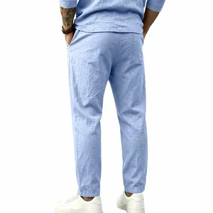 Back view of men's loose light blue cotton linen pants featuring a straight leg fit