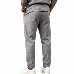 Detail view of men's loose grey cotton linen trousers for a casual holiday look.