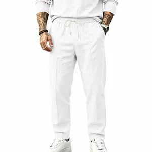 Men's white linen trousers featuring a comfortable drawstring waist and straight leg cut