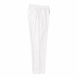 Detailed side view of white cotton linen resort style pants with elastic waist