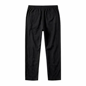 Detailed back view of casual black cotton linen trousers with elastic waist and pocket