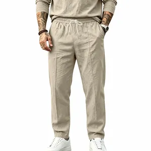 Close-up of men's cotton linen straight leg trousers featuring a drawstring waist