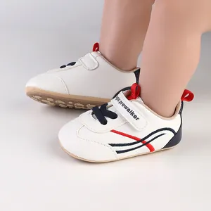 Close-up of white infant pre-walker shoes with soft anti-slip soles and velcro straps
