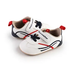 Side view detail of breathable white baby prewalker shoes with red and navy stripes