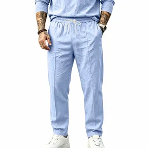 Close-up of light blue cotton-linen blend pants in a relaxed straight-leg fit.