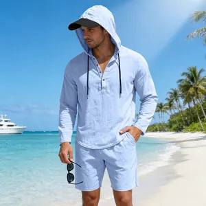 Relaxed light blue linen hooded Henley set for men during a sunny tropical beach vacation.