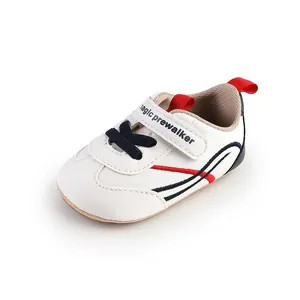 Detailed view of white baby pre-walker shoe with soft sole and hook-and-loop strap.