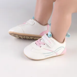 Detailed view of soft sole baby pre-walker shoes in white with pink and blue accents.