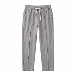 Grey loose fit cotton linen trousers with drawstring waist and straight leg design