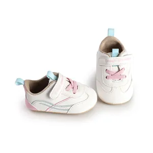 White leather infant pre-walker shoes featuring pink laces and velcro strap detail