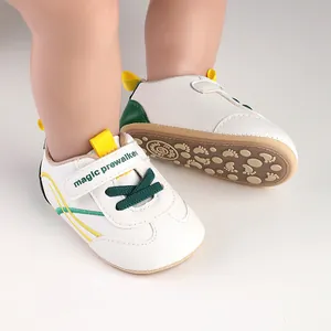 Close-up detail of white and green baby pre-walker shoes with anti-slip rubber soft soles