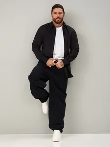 Full-body view of men's loose straight black denim pants featuring a relaxed casual styling