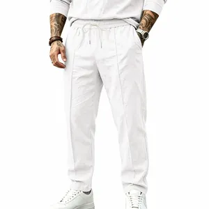 Casual men's white cotton linen trousers with loose fit and drawstring waist detail