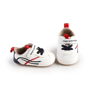 White baby pre-walker shoes with navy and red stripes, detailed product view.