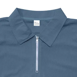 Gros plan détaillé d'un polo en velours côtelé bleu avec détail quart de zip argenté