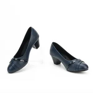 Detailed view of navy blue minimalist block heel pumps for professional office wear.