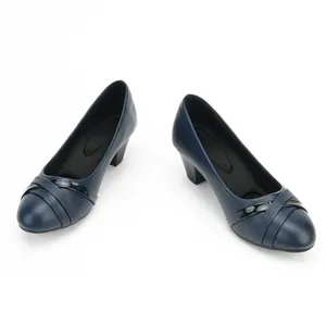 Detail view of navy blue block heel pumps with cross strap accents for workwear.