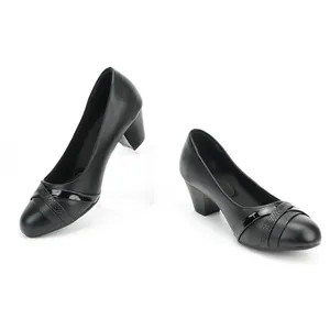 Detail view of black women's block heel pumps with elegant strap design.