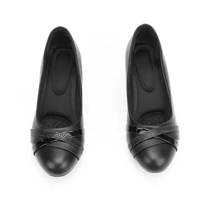 Professional macro top view of black work shoes with stylish crisscross strap detail.
