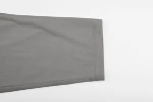 Detailed close-up showing the fine corduroy fabric texture and hem of gray men's suit