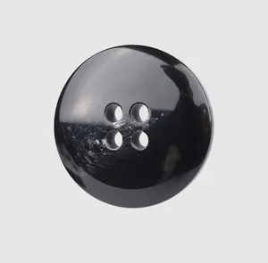 Macro detail view showing the glossy finish of a premium black 4-hole resin button.