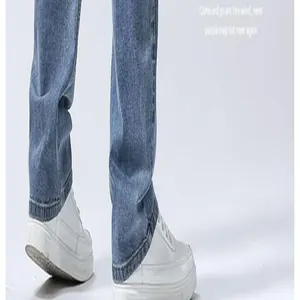Close-up of men's casual straight-leg blue jeans and white sneakers
