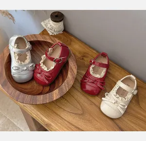 Close-up detail of girls' lace-trimmed Mary Jane shoes with bow decoration in three colors
