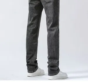 Detailed back view of men's dark grey straight leg denim jeans showing fit and hemline