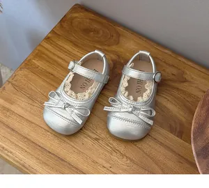 Elegant silver Mary Jane shoes for girls featuring delicate lace trim and cute bow accent