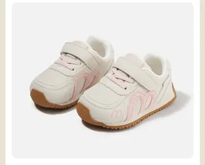 Detailed view of children's pink and white velcro sneakers with soft anti-slip soles