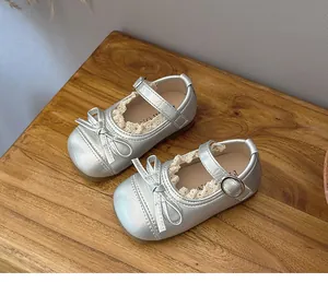 Detail view of silver girls Mary Jane shoes with delicate lace trim and elegant bow accent.