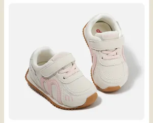 Side view detail of children's cream and pink non-slip casual sports shoes with velcro strap.